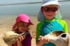 Two kids showing off the shells they found on the 10,000 Island Shelling Tour in Goodland Florida USA.