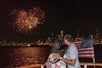 A couple of people watching the fireworks over Chicago on the 3D Fireworks Cruise in Chicago Illinois.