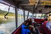 A look at the inside of the Explorer Jetboat with passengers filling the red cushioned seats.