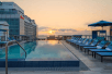 Outdoor pool with sun loungers and sun umbrellas at AC Hotel by Marriott Miami Beach, FL.