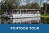 A pontoon boat full of people and a blue box saying "Pontoon Tour" with Adventures of Jean Lafitte in New Orleans, Louisiana, USA.
