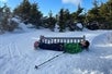 Guest lays down on a snow-covered bench during his tour