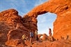 One of the tour guides talking with some guests about the arches and admiring their beauty on the Arches National Park Sunset Discovery Tour Moab Utah.
