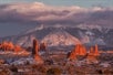 A beautiful ariel view of some rock formations and the mountains int he background on the Arches National Park Sunset Discovery Tour Moab Utah.