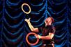 A juggler showcasing feats of dexterity as he tosses orange rings in Array, Pigeon Forge’s newest variety show.