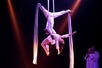 Amazing aerialists soar gracefully over the Array stage in a mid-air white ribbon performance.