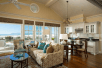 Beachfront guest room with sofa bed, dining area, wet bar, and balcony.