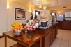 Breakfast area with assorted fresh fruits and breakfast items.