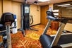 Fitness center with cardio equipment and weights. 