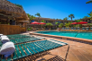 Outdoor pool with sun loungers at Best Western Naples Inn & Suites, FL.