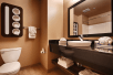 Guest bathroom with mirror, toilet, sink, and towels.