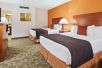 2 Queen beds in a spacious guest room at Best Western Plus University Inn.