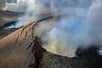 Smoke pluming out of the crater of a volcano on the Big Island Spectacular Helicopter Tour in Hawaii USA.