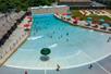 Aerial view looking down on an outdoor wave pool full of people on a sunny day at Big Kahuna's Water Park