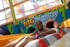 Two young girls in tubes on a water slide smiling with a more slides behind them at the Big Kahuna's Water Park.