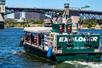 The Explorer Jetboat as it heads toward Burnside Bridge on a sunny day with the city in the background.