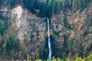 Wide shot of Multnomah Falls waterfall surrounded by trees from Explorer Jetboat.