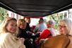 Guests are all smiles as they embark on the Boozy Brunch tour in St. Augustine, riding in style on an open-air electric vehicle with their friendly chauffeur.