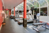 Fitness center with treadmills, ellipticals, and a training bench.