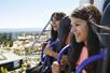 Two young women smiling in the air while riding the Drop Tower at California's Great America in San Francisco, California.