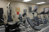 Fitness center with treadmills, bench press, and other gym equipment.