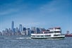 The Circle Line Bronx cruising in the water with the cityscape in the background