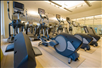 Modern fitness center with a variety of equipment, designed for a complete workout experience.