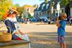 Kid taking a photo of a woman in costume at Colonial Williamsburg in Williamsburg, Virginia