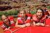 Some kids having a great time rafting down the Colorado River on the Colorado River Full-Day Rafting Adventure in Moab Utah.
