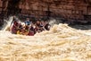 These rafters are hitting some serious rapids and loving every minute of it on the Colorado River Full-Day Rafting Adventure in Moab Utah.