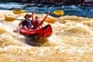 A father and his son having a great time going over the rapids in their raft on the Colorado River Full-Day Rafting Adventure in Moab Utah.