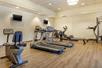 A fitness center with several pieces of cardio equipment and a few weight machines at the Comfort Inn Denver Central.