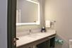 A well-lit vanity area inside a private bathroom.