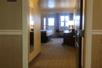 A hotel room entrance with a bed and desk in the room at the Comfort Inn & Suites Ukiah Mendocino County.