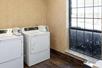 Guest laundry with washing machine and dryers.