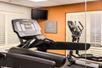 Fitness room with treadmills, panel TV and other cardio equipment.