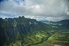 A helicopter flying along the mountains in Oahu on the Complete Island Oahu Helicopter Tour in Hawaii USA.