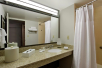 Private bathroom with vanity area and toiletries.