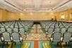Meeting facility with carpeted floors and ample seating.