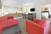 Suite - Seating Area with Sofa at Days Inn by Wyndham Irving Grapevine DFW Airport North, TX.