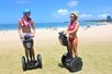 Two Girls on their segway's on the beach on the Diamond Head Segway Tour, Honolulu Hawaii.