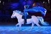 Aerialist riding a white horse at Dolly Parton's Stampede Dinner and Show Attraction.