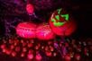 A giant jack o'lantern man laying in his side with smaller jack o’lanterns surrounding  him at Dollywood in Pigeon Forge, Tennessee, USA.