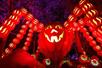 A giant spider with a jack o'lantern for a head and smaller pumpkins making the legs at night at Dollywood in Pigeon Forge, Tennessee, USA.