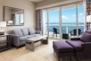 Living area with sofa and private balcony at DoubleTree by Hilton Grand Hotel Biscayne Bay, FL. 