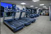 Fitness center with treadmills, elliptical trainers, and other gym equipment.