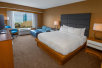 1 King bed, sofa bed, flat-screen TV and work desk inside a guest room at DoubleTree by Hilton Hotel Niagara Falls New York, Niagara Falls, NY. 