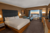 1 King bed, sofa bed, flat-screen TV and work desk inside a guest room at DoubleTree by Hilton Hotel Niagara Falls New York, Niagara Falls, NY. 