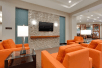 Lounge with flat screen TV at Drury Inn & Suites Charlotte Arrowood.