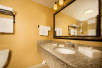 Fresh towels and bathroom amenities inside a private bathroom at Drury Inn & Suites Phoenix Airport, AZ.
